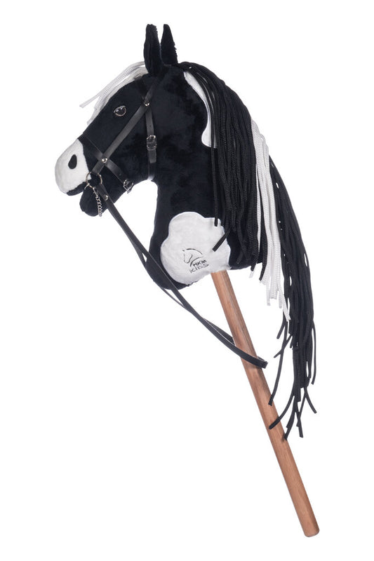 freigestelltes hkm hobby horse schwarz geflecktes fell mit trense in der seitenansicht